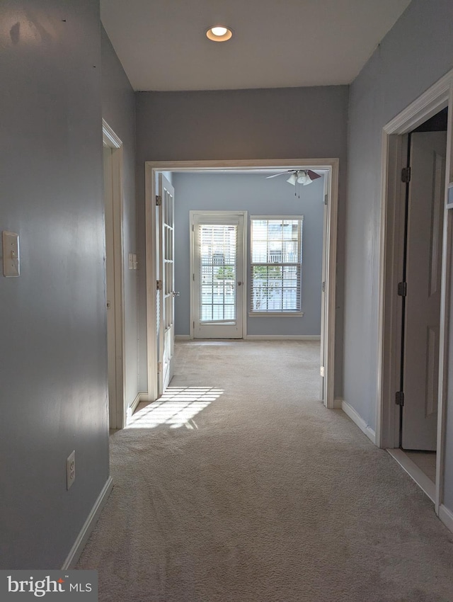 hallway with light colored carpet, baseboards, and recessed lighting