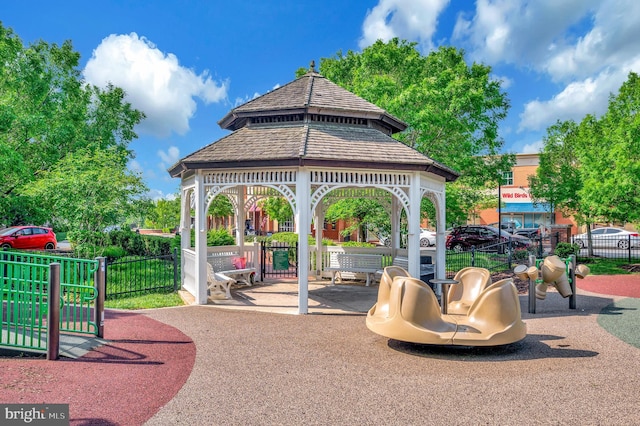 view of jungle gym with a gazebo and fence