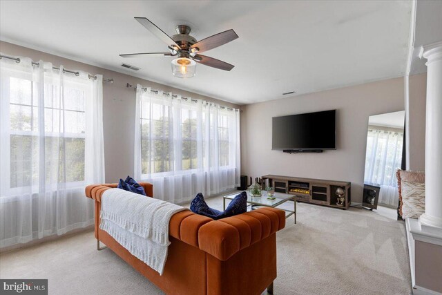 living room featuring carpet, healthy amount of natural light, and ceiling fan