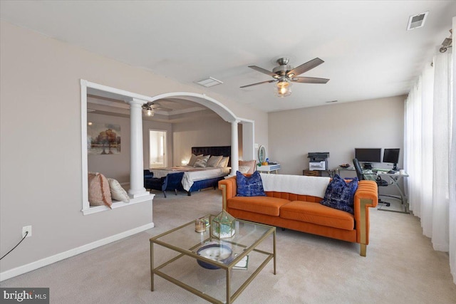 bedroom featuring decorative columns, arched walkways, light carpet, and multiple windows