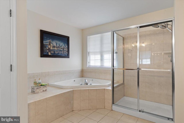 full bath with a stall shower, tile patterned floors, and a bath