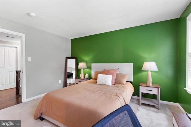 carpeted bedroom featuring baseboards