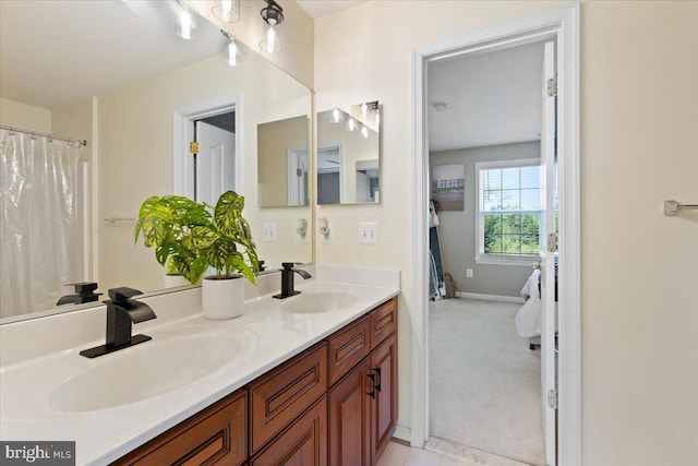 bathroom featuring double vanity and baseboards