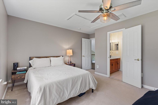bedroom featuring light carpet, attic access, baseboards, and connected bathroom