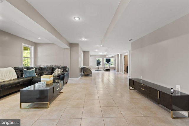 living area with recessed lighting, light tile patterned floors, plenty of natural light, and baseboards