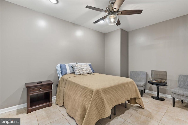 bedroom with light tile patterned floors, baseboards, and a ceiling fan