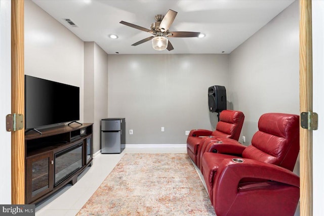 home theater room with a ceiling fan, light tile patterned floors, recessed lighting, and baseboards