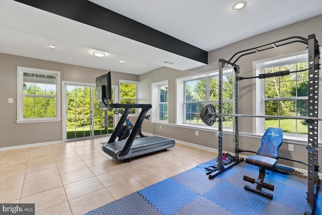 exercise room featuring baseboards, tile patterned floors, and recessed lighting
