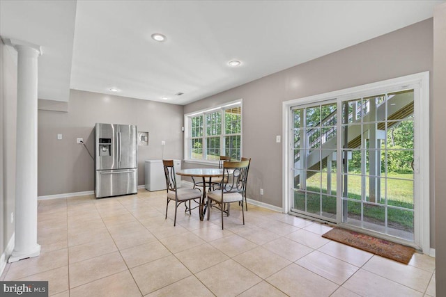 dining room featuring decorative columns, light tile patterned flooring, baseboards, and recessed lighting