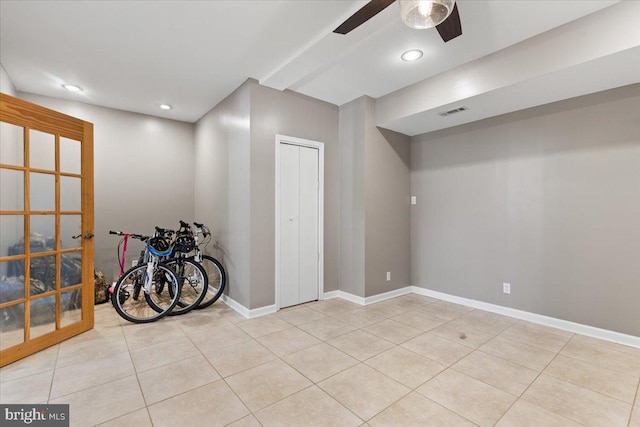 below grade area featuring tile patterned flooring, ceiling fan, recessed lighting, and baseboards