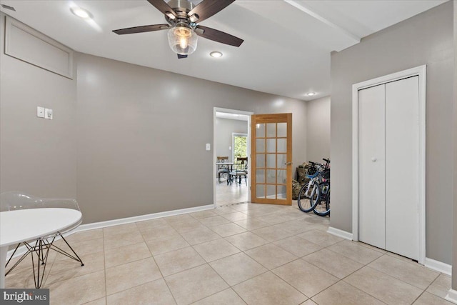 interior space featuring a ceiling fan, recessed lighting, baseboards, light tile patterned floors, and french doors