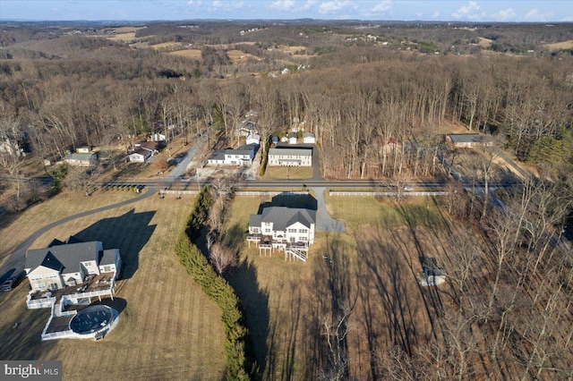 aerial view of property's location with a heavily wooded area