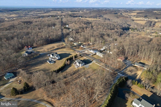 aerial view of property's location with a heavily wooded area