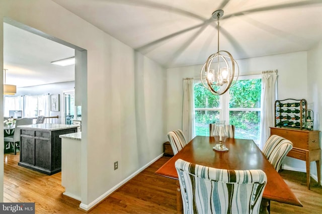 16068 Hayes Ln, Woodbridge, VA 22191 - dining room featuring a chandelier, wood finished floors, and baseboards