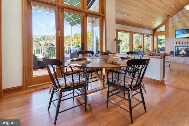 1402 Thurston Rd, Dickerson, MD 20842 - dining area featuring healthy amount of natural light, light wood finished floors, a brick fireplace, lofted ceiling, and wooden ceiling