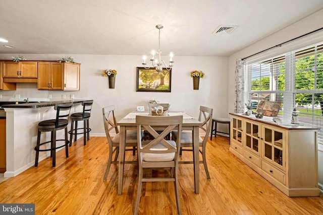 43 Ivy Ln, Gettysburg, PA 17325 - dining space with light wood-type flooring, a chandelier, and baseboards