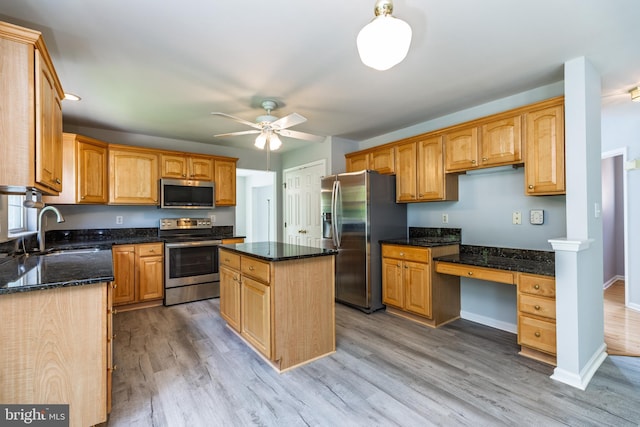 460 Preakness Run, Newark, DE 19702 - kitchen with appliances with stainless steel finishes, a sink, a ceiling fan, dark stone countertops, and light wood-style flooring