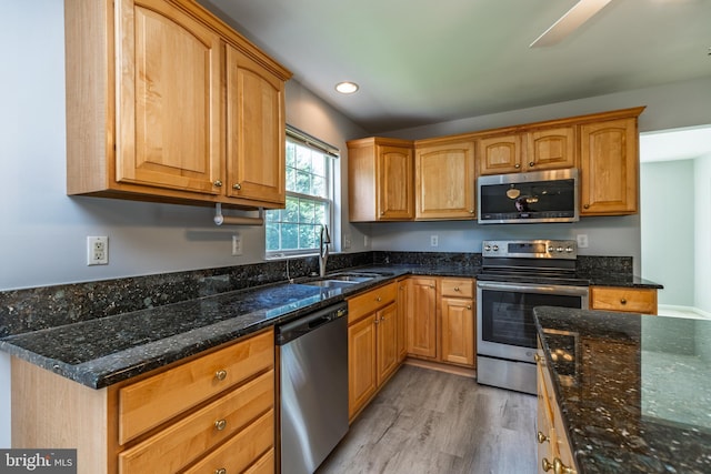 460 Preakness Run, Newark, DE 19702 - kitchen with stainless steel appliances, a sink, light wood finished floors, dark stone counters, and recessed lighting