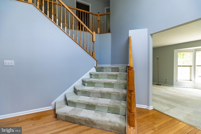 460 Preakness Run, Newark, DE 19702 - stairway with wood-type flooring, baseboards, and a towering ceiling
