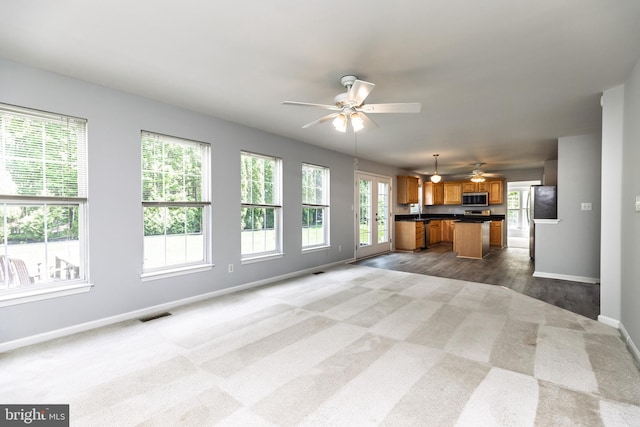 460 Preakness Run, Newark, DE 19702 - unfurnished living room featuring ceiling fan, baseboards, carpet flooring, and wood finished floors