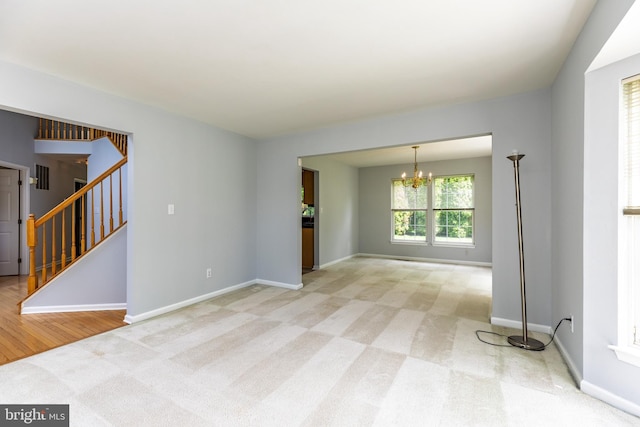 460 Preakness Run, Newark, DE 19702 - unfurnished room with a chandelier, stairs, light carpet, and baseboards