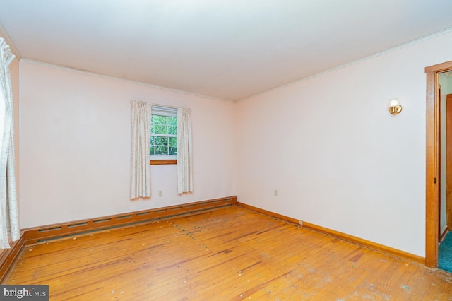 148 N Good Spring Rd, Hegins, PA 17938 - empty room with wood-type flooring, ornamental molding, baseboards, and a baseboard radiator