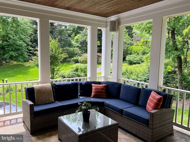 sunroom / solarium featuring crown molding, an outdoor hangout area, wooden ceiling, and view of scattered trees
