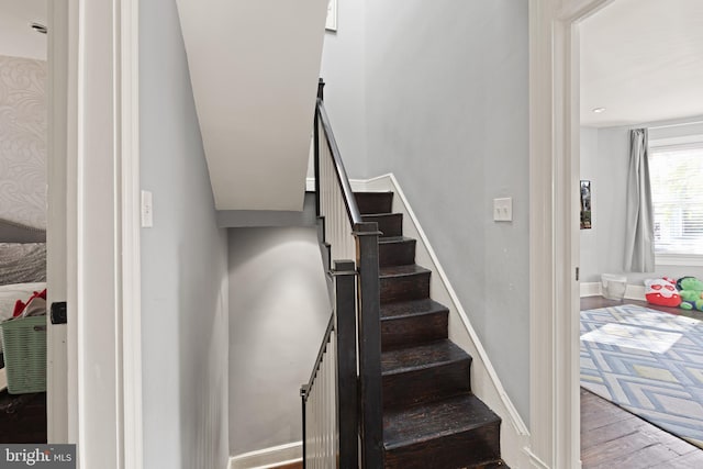 stairs featuring hardwood / wood-style floors