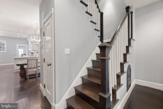 stairs featuring wood finished floors, baseboards, and recessed lighting