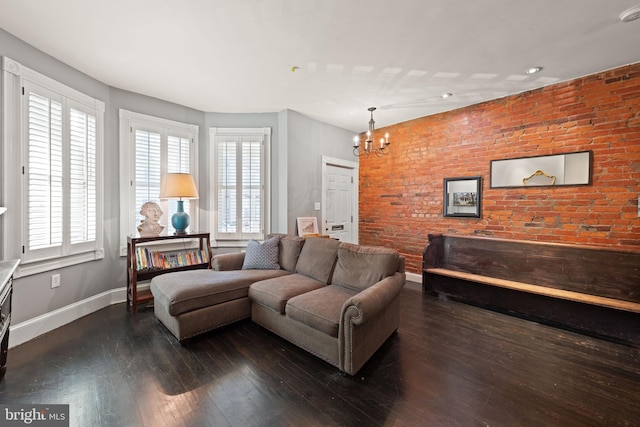 living area featuring a chandelier, baseboards, and dark wood-type flooring