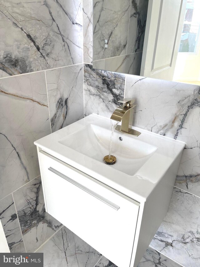 bathroom view of tile walls and vanity