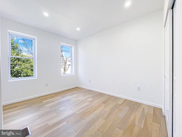 unfurnished bedroom with light wood-type flooring, recessed lighting, and baseboards