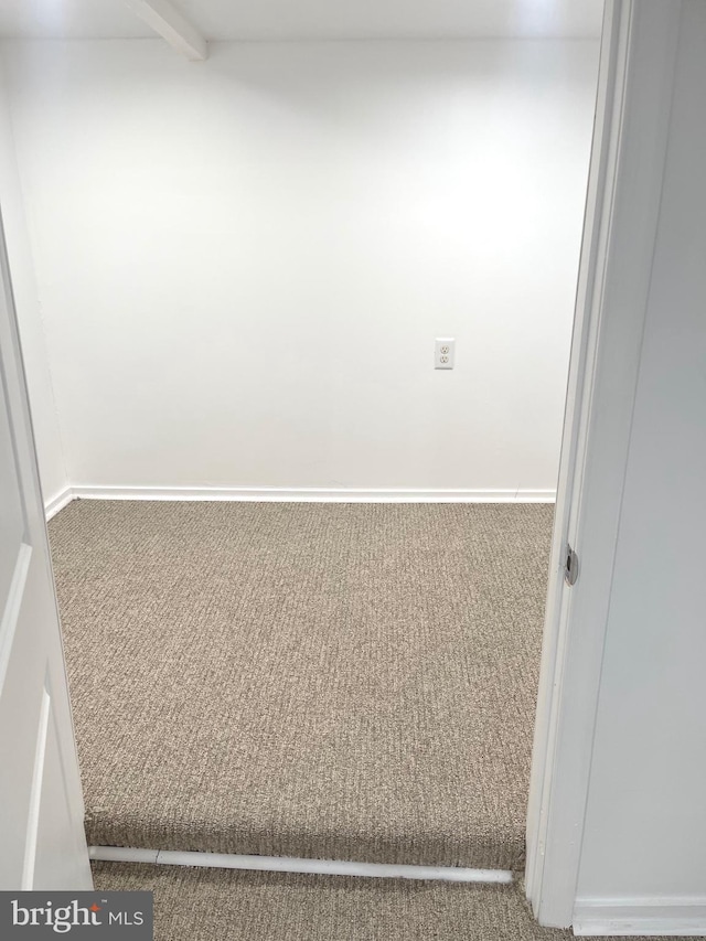 unfurnished room with carpet floors and baseboards