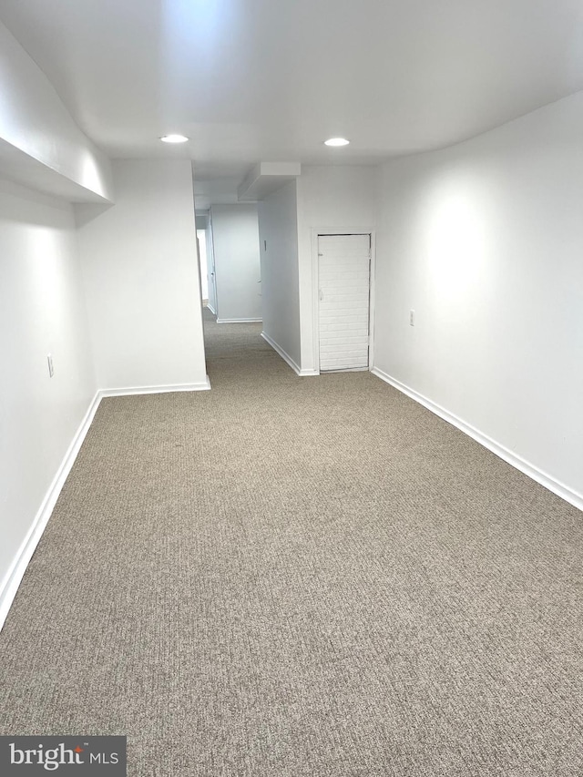 finished basement with carpet floors, baseboards, and recessed lighting