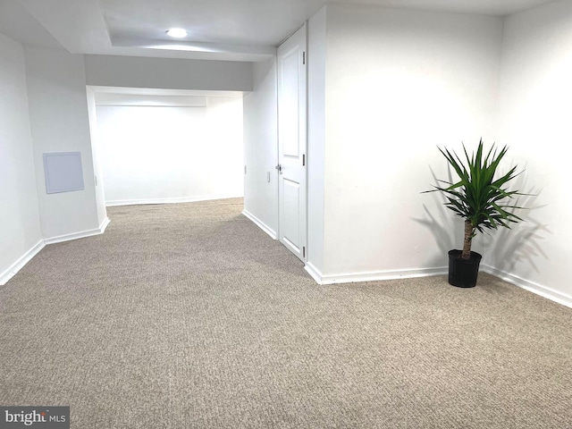 corridor with carpet flooring and baseboards
