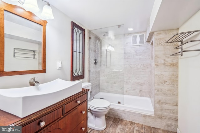 10407 Edgefield, Hyattsville, MD 20783 - bathroom featuring toilet, a walk in shower, vanity, and wood finished floors