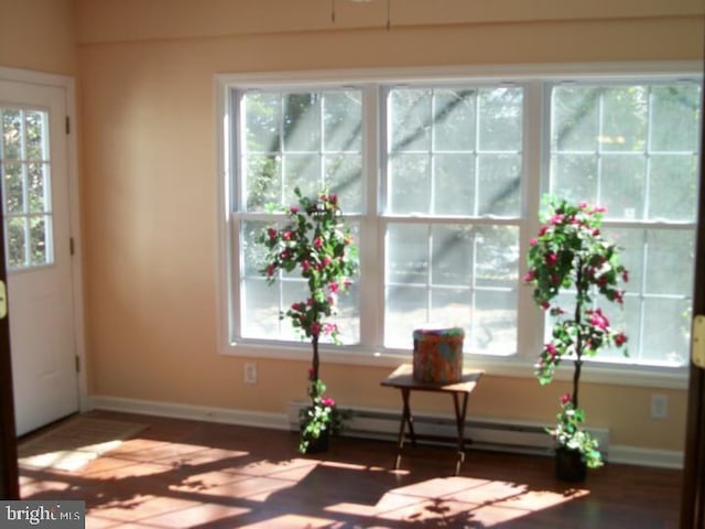810 Hughes Dr, Hamilton, NJ 08690 - doorway to outside with a baseboard heating unit, wood finished floors, and baseboards