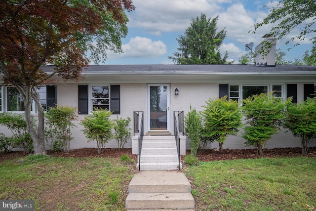 view of front of property with a front yard and brick siding