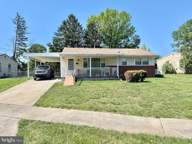 view of front of home with covered porch, concrete driveway, brick siding, and an attached carport