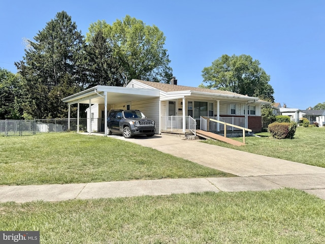 view of front of property with concrete driveway, a carport, covered porch, and a chimney