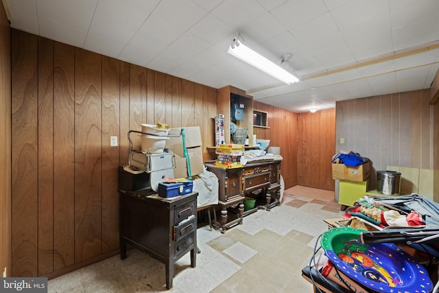finished below grade area with light flooring and wood walls