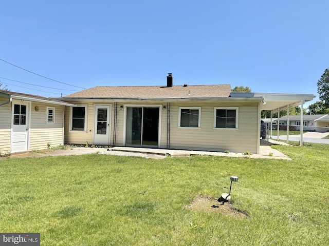 back of property with roof with shingles