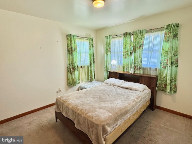 bedroom with carpet flooring and baseboards