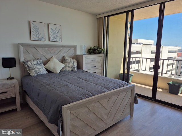 bedroom with wood finished floors and a textured ceiling