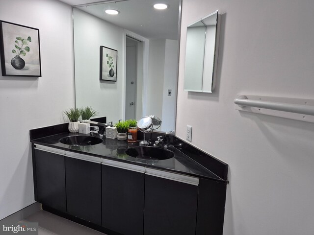 bathroom with recessed lighting and double vanity