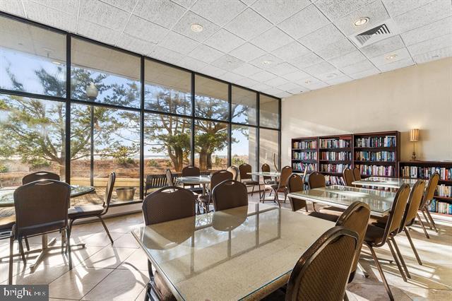 dining space with expansive windows and light tile patterned floors