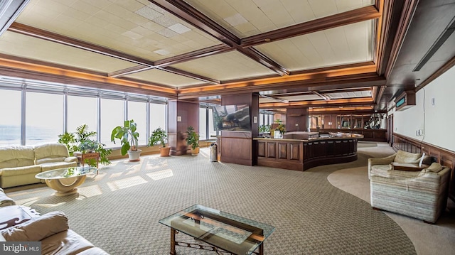 community lobby with coffered ceiling, beam ceiling, a water view, and crown molding