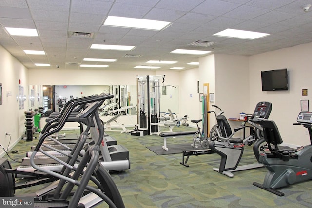 workout area with a paneled ceiling and carpet flooring