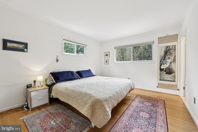 5417 Gary Pl, Alexandria, VA 22311 - bedroom featuring multiple windows, light wood finished floors, and baseboards