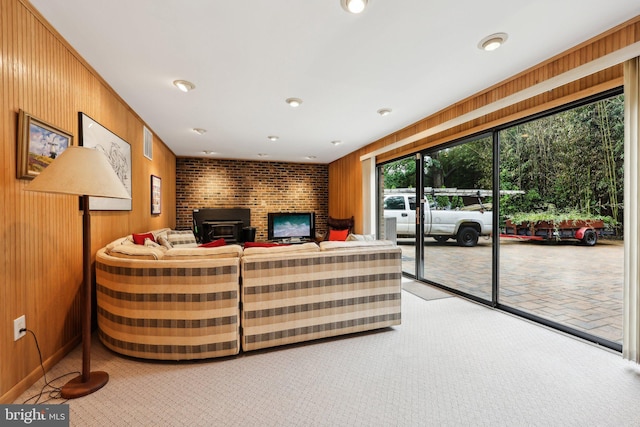 5417 Gary Pl, Alexandria, VA 22311 - living area with wood walls, carpet floors, recessed lighting, and a wood stove